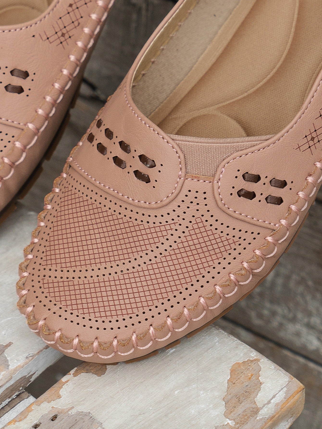 Pink women's stitched laser-cut flat loafers detail