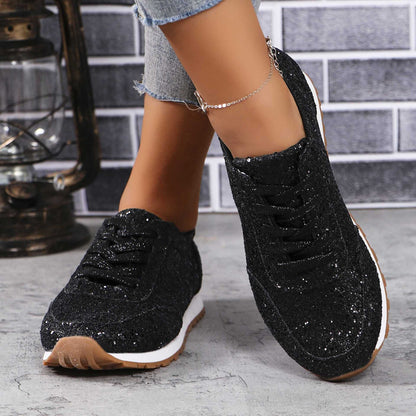 Black sequin lace-up sneakers worn on foot
