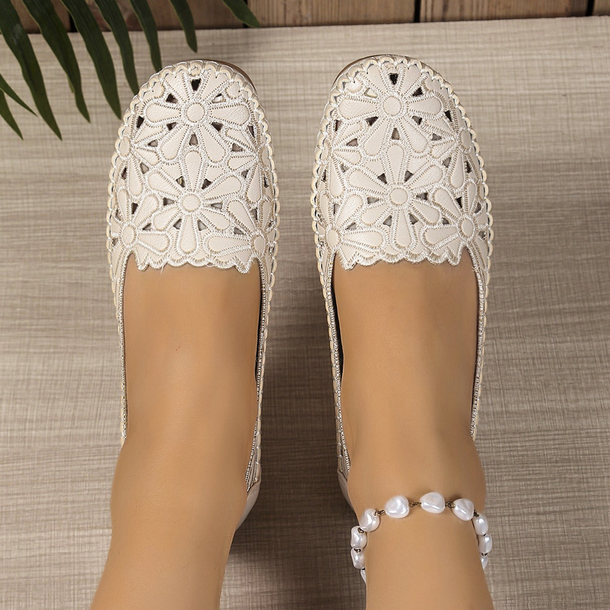 White floral cutout loafers close top view