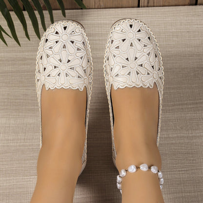 White floral cutout loafers close top view