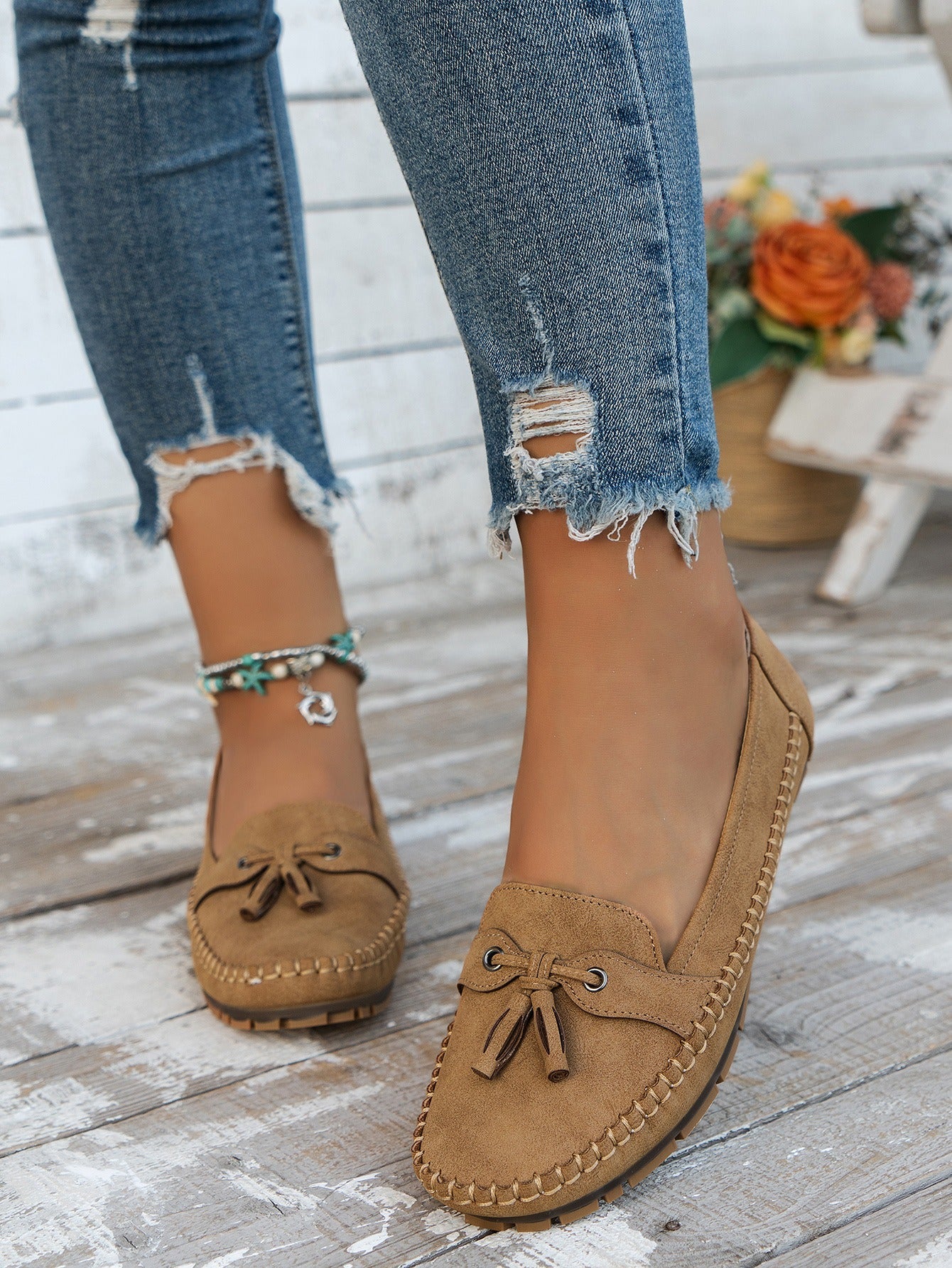 Women's apricot tassel loafers front view on foot
