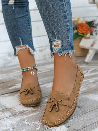 Women's apricot tassel loafers front view on foot