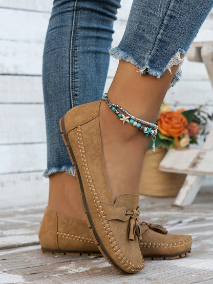 Women's apricot tassel loafers side view on foot