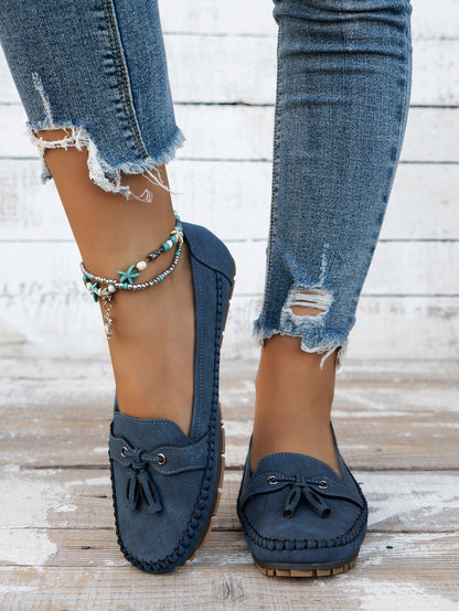 Women's blue tassel loafers front view on foot