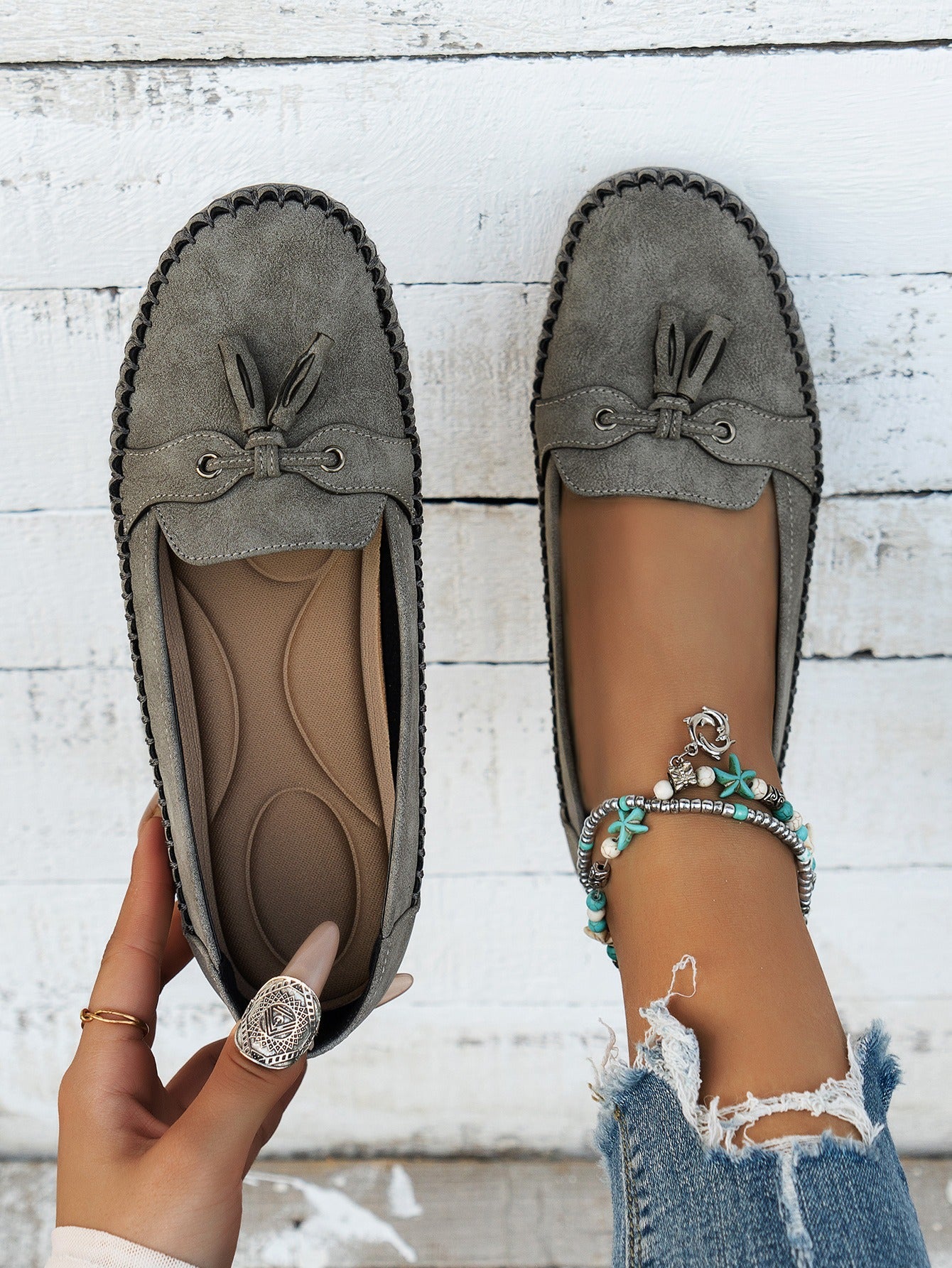 Women's gray tassel loafers top view and cushioned footbed