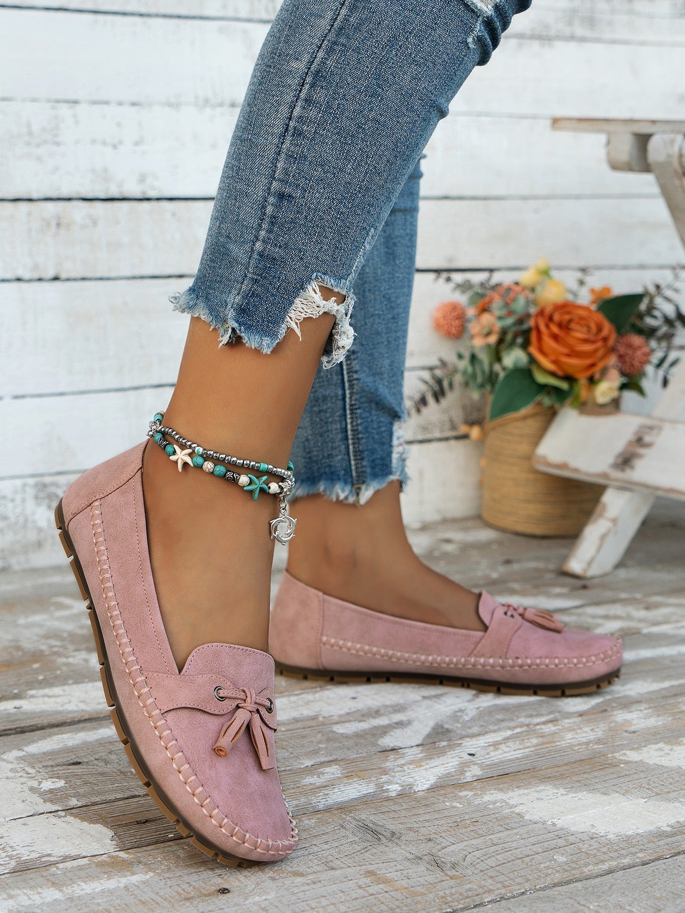 Women's pink tassel loafers front view on foot