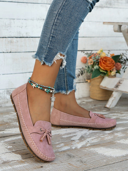 Women's pink tassel loafers front view on foot