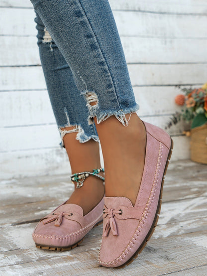 Women's pink tassel loafers side view on foot